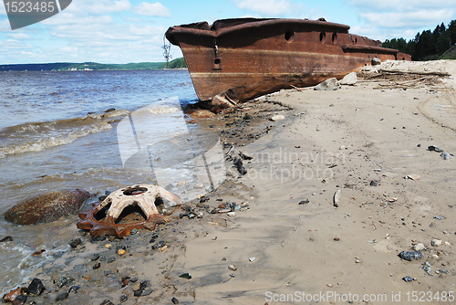 Image of rusty ship on the shore of  Ob river in Russia