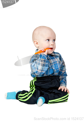 Image of A small child with an orange spoon