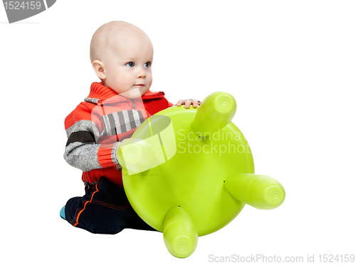 Image of little boy with a plastic chair in the studio