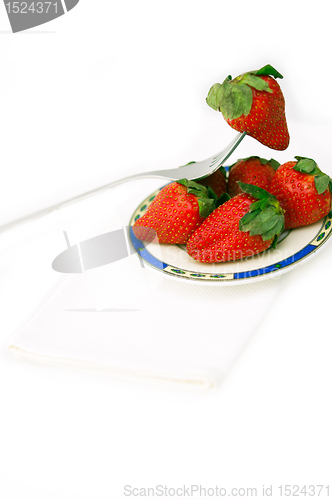 Image of fresh strawberries dish over white