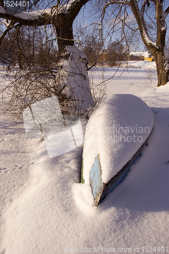 Image of Boat covered by snow. 