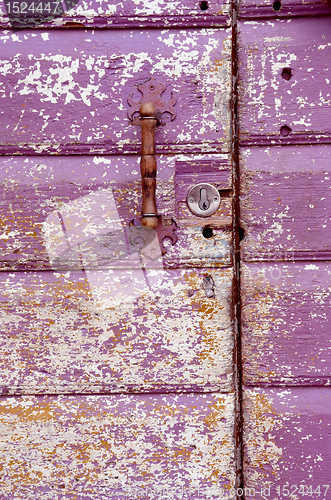 Image of Old painted, crumbled door.