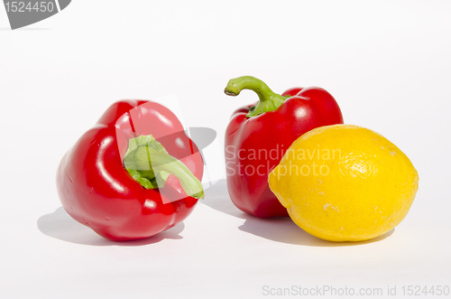 Image of Red paprikas and yellow lemon.