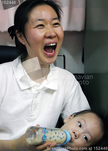 Image of Mother feeding her baby - surprised expression