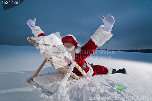 Image of Santa relaxing on a sunbed
