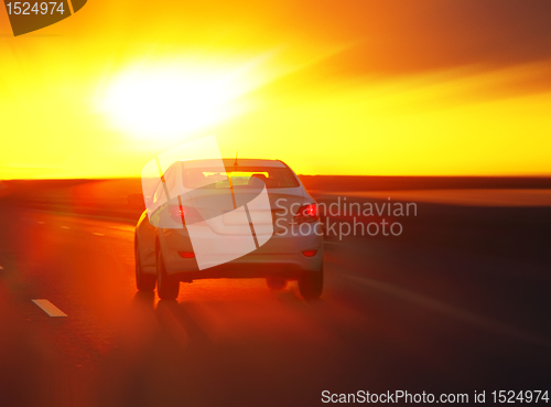 Image of car at sunset on the highway