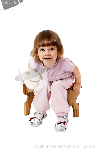 Image of little girl sitting on a wooden stool
