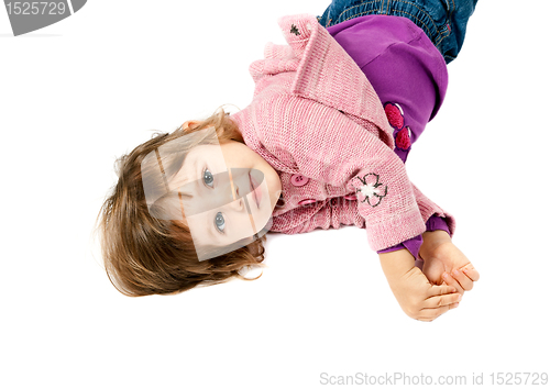 Image of little girl lying on white floor 
