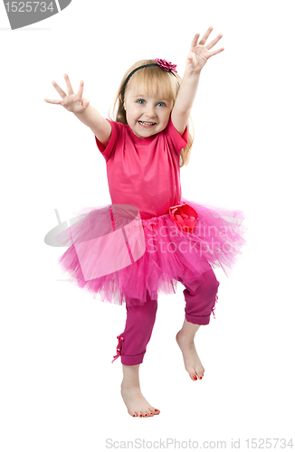 Image of little girl in a pink dress dancing in studio