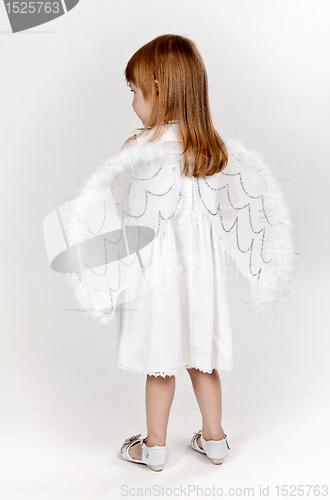 Image of little girl with angel wings in the studio