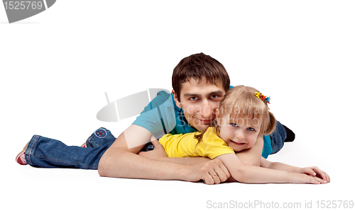 Image of dad and little daughter lying on the floor