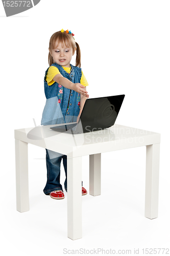Image of little girl with a laptop at a table