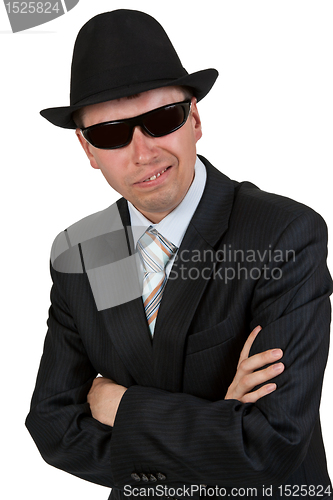 Image of businessman in dark glasses and a hat