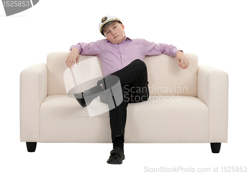 Image of Serious young boy wearing a cap captain