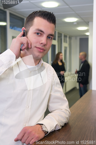 Image of Young Businessman with Colleagues