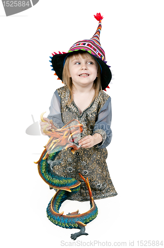 Image of Little girl sitting on the floor with a decorative dragon 