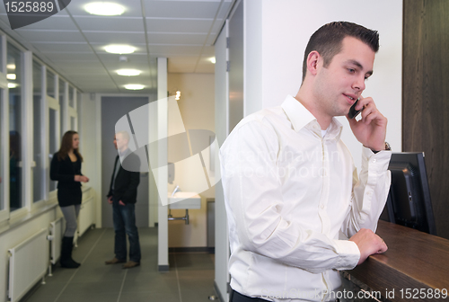 Image of Young Businessman with Colleagues