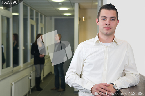 Image of Young Businessman with Colleagues