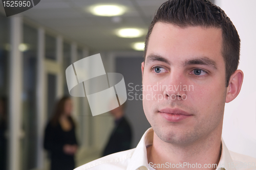 Image of Young Businessman with Colleagues