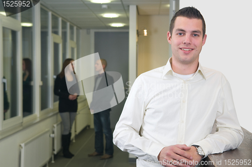 Image of Young Businessman with Colleagues