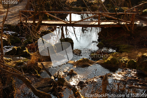 Image of Stream and wooden bridge