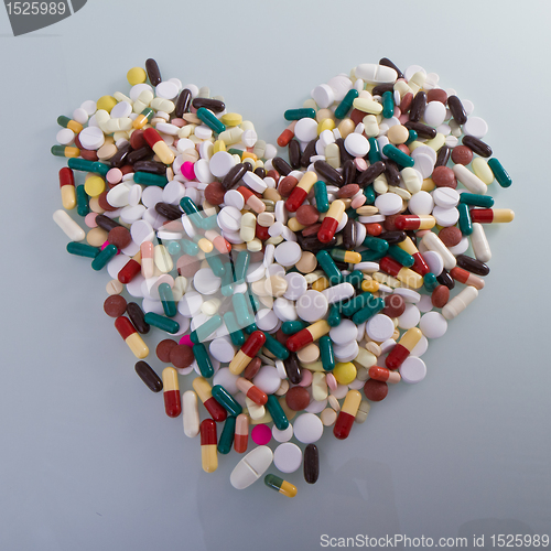 Image of various pills in a shape of heart