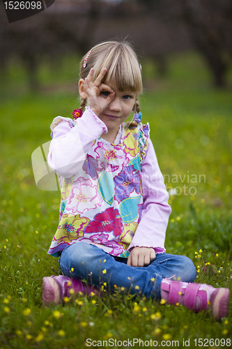 Image of Little girl outdoors with imaginary binoculars
