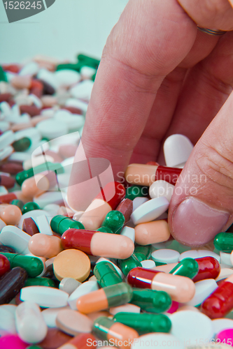 Image of hand grabbing pills