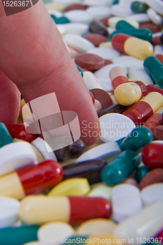 Image of hand grabbing pills