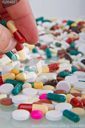 Image of hand grabbing pills