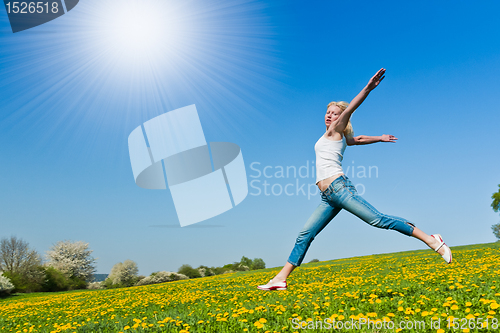 Image of happy young woman on meadow