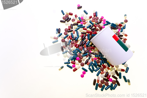 Image of pills spilling out of container 
