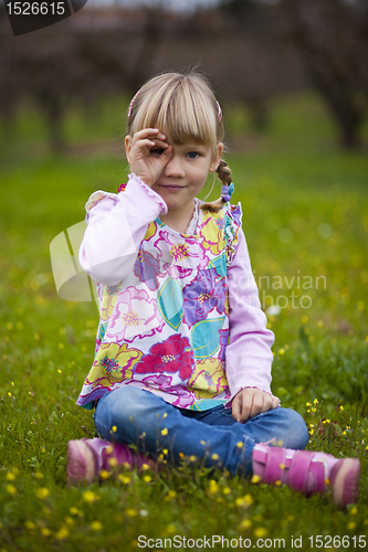 Image of Little girl outdoors with imaginary binoculars