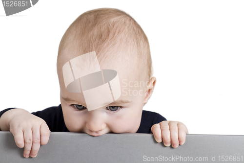 Image of young child holding horizontal sign