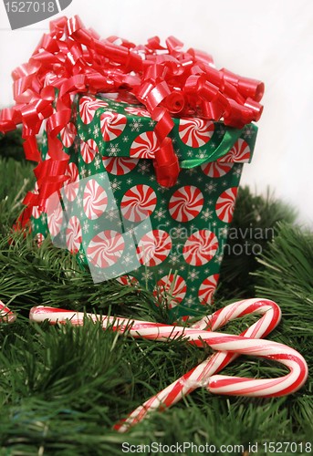 Image of Christmas box on garland and candy canes