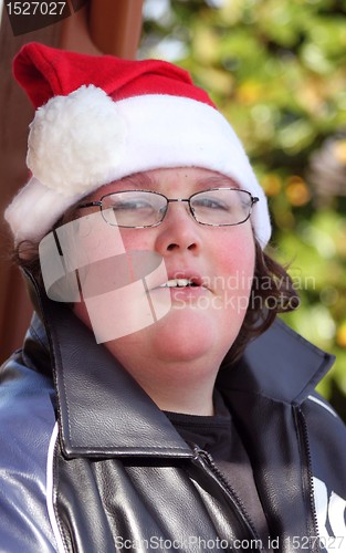 Image of Young man wearing Santa hat