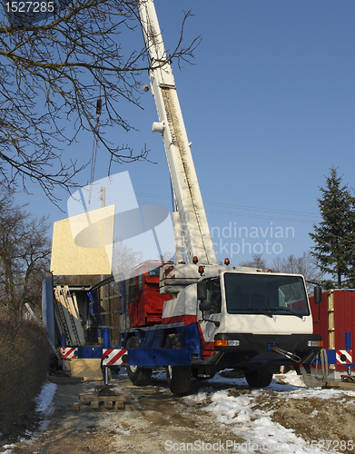 Image of wooden house construction at winter time