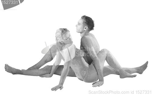 Image of muddy couple sitting into each other
