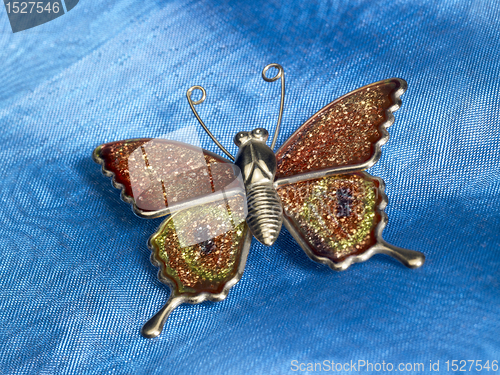 Image of butterfly trinket ob blue fabrics