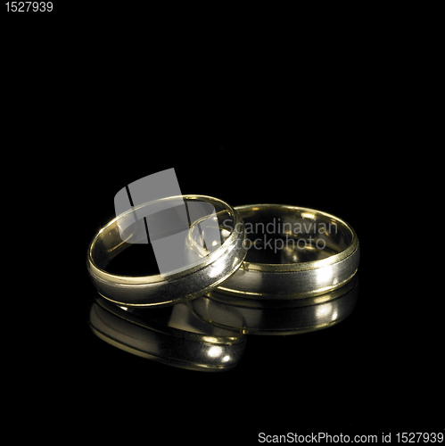 Image of wedding rings in black back