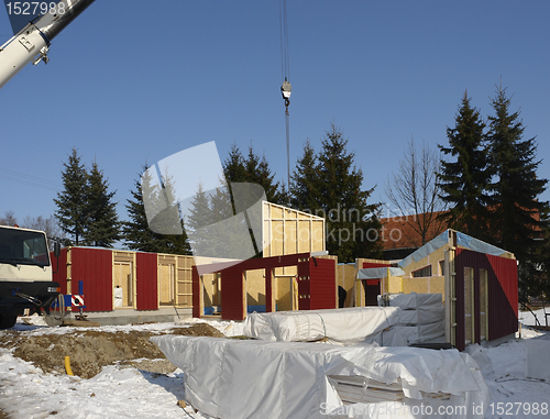 Image of wooden house construction in sunny ambiance