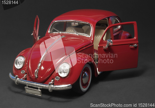 Image of red model car with open doors