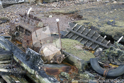 Image of rotten boat with engine