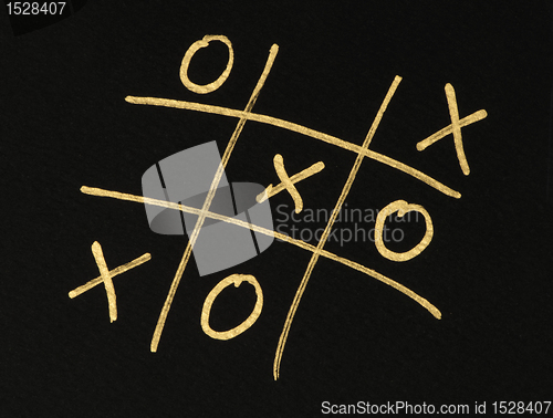 Image of Hand-drawn tic-tac-toe game over black