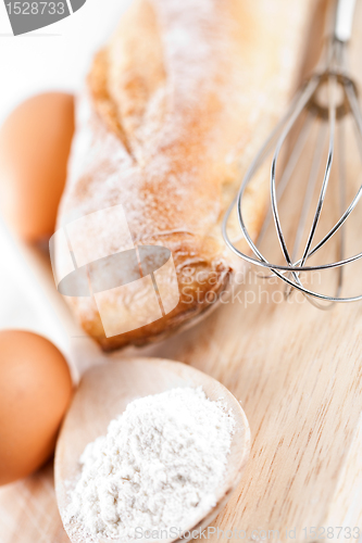 Image of bread, flour, eggs and kitchen utensil 