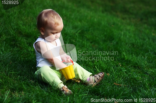 Image of Little boy on a green grass