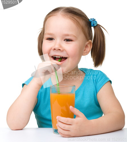 Image of Little girl drinks orange juice