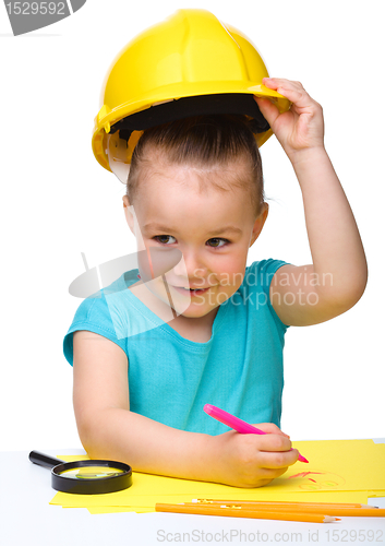 Image of Cute little girl draw with marker wearing hard hat