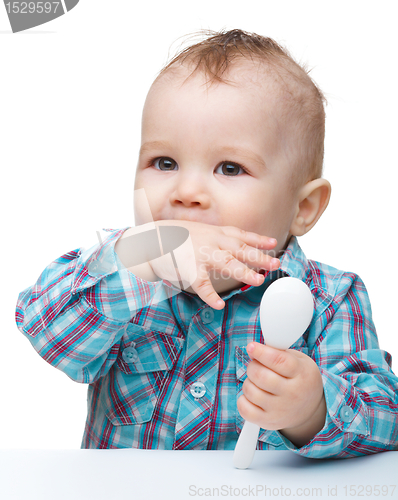 Image of Cute little boy is biting his finger