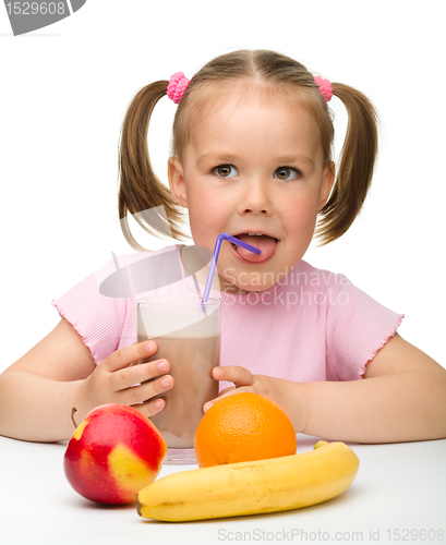 Image of Little girl drinks fruit juice